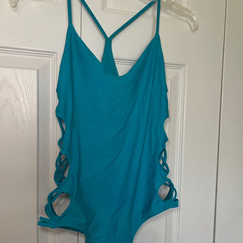 Women’s body glove one piece cut out swimsuit. New without tags. Turquoise blue